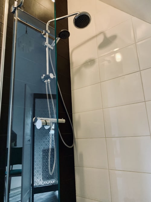 Modern shower enclosure with dual showerheads at l'Atelier des Dépendances in Lipsheim