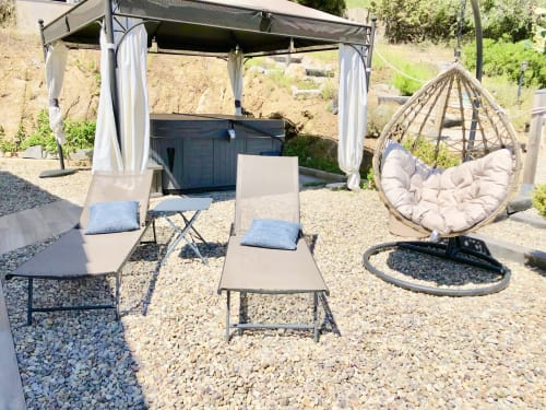 Villas Marincelu outdoor patio with pergola, loungers, hanging chair, and fire pit in Serra di Ferro