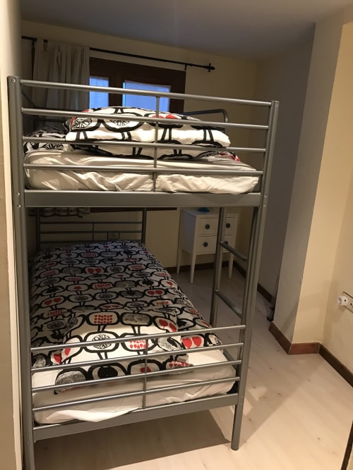 Metal bunk beds with patterned bedding in apartment bedroom at Urrondo hotel, Lekeitio