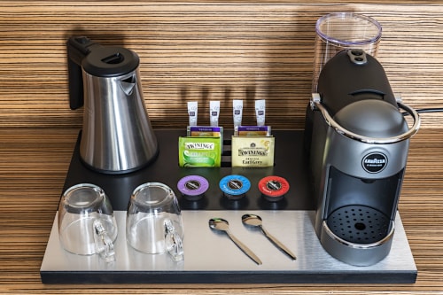Hotel Residence Europe & Spa Junior Suite welcome tray with electric kettle, coffee machine, glasses, and Twinings tea