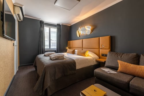 Executive Room at Hotel Residence Europe & Spa, Clichy featuring orange headboard, dark walls, and modern amenities