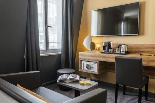 Executive Room at Hotel Residence Europe & Spa in Clichy with work desk, TV, seating area and window