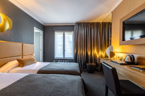 Superior Room at Hotel Residence Europe & Spa in Clichy with twin beds, gold headboard, and modern decor