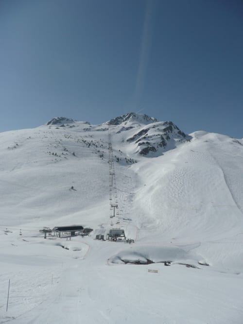 Besneeuwde skiresort met stoeltjeslift en berghutte in Fontcouverte-La Toussuire, bij Chalet La Louvière
