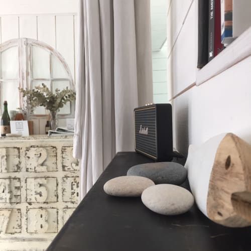 Modernes Küstenregal im Schlafzimmer mit glatten Steinen, Lautsprecher und Büchern im Les Filles du Bord de Mer, Port-en-Bessin
