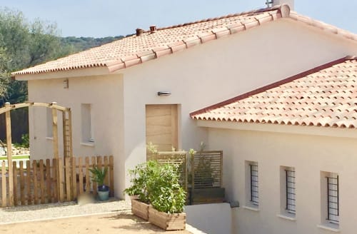 Casa Felice villa at Villas Marincelu with terracotta roof, cream walls, wooden gate, garden planters, and private pool area