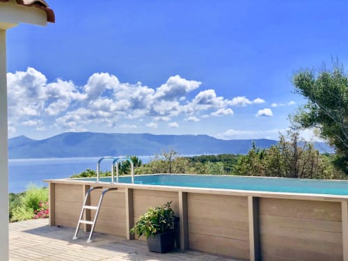 Heated pool with sea view overlooking mountains at Casa Alta villa, Corsica