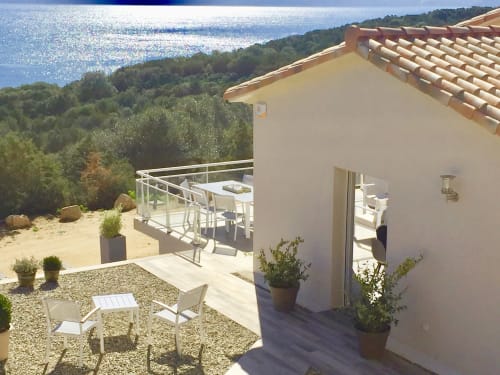 Casa Serena villa terrace with sea view, loungers, and dining area overlooking Corsican coast near Porto Pollo