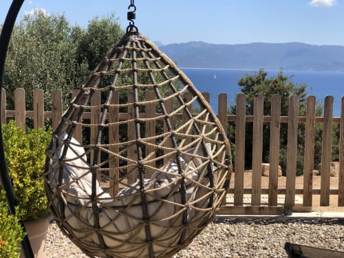 Hanging egg chair on terrace overlooking Corsican sea at Casa Serena villa, Villas Marincelu