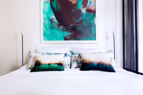 Modern bedroom at MONTMARTRE ROMANTIC Paris with turquoise abstract artwork, colorful pillows, and white bedding