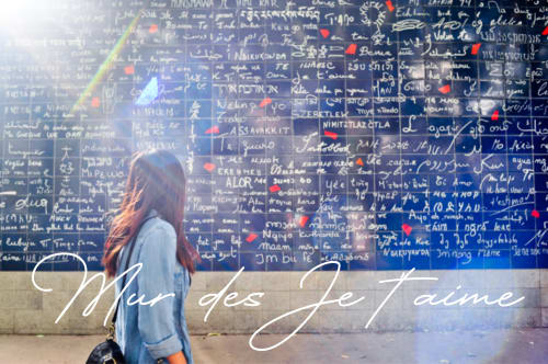 Woman at Paris wall with multilingual 'Mur des Je t'aime' mural near Montmartre Romantic B&B