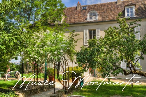 Charming garden courtyard at Montmartre Romantic B&B Paris, with lush greenery and classic French architecture