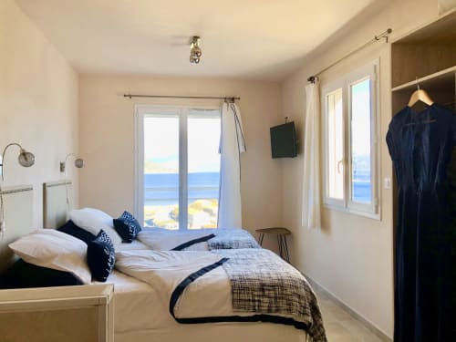 Bright bedroom with sea view at Villas Marincelu, Corsica. Twin beds, modern furnishings, terrace doors overlooking