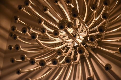 Elegant glass chandelier with brass accents at Mas De Lafeuillade boutique hotel in Montpellier