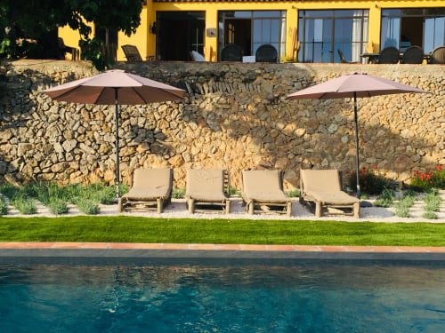 Saint Martin B&B pool area in Ollioules with loungers, umbrellas and stone terrace backdrop
