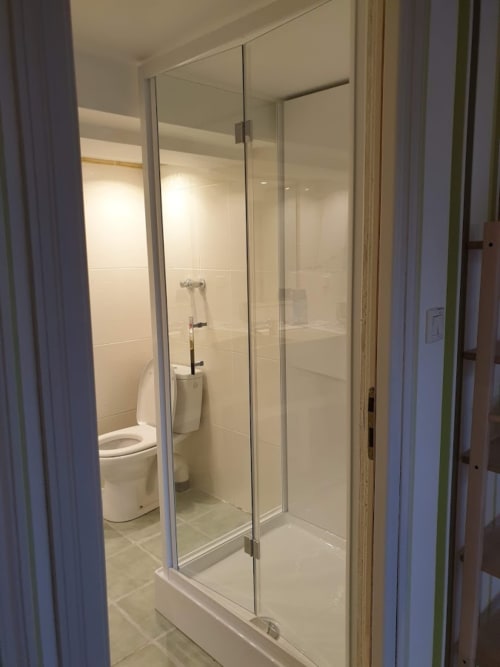 Modern glass-enclosed shower with white tile walls in Bambou room at Villa Thébaïde, Laudun L'Ardoise