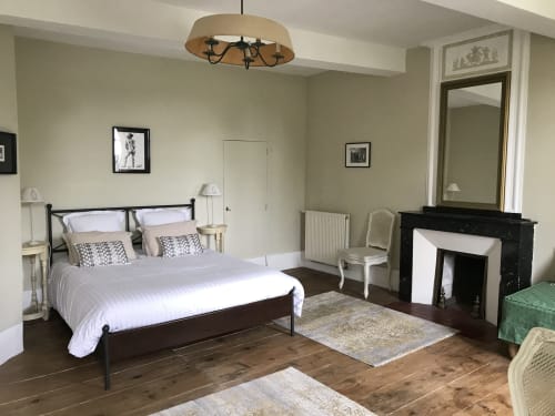 Élégante chambre double à L'affable B&B avec vue sur le jardin, lit en fer forgé, cheminée et mobilier d'époque