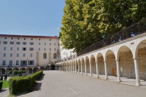 Cour à colonnade du Cocon De Curson, une maison d'hôtes française à Chanos-Curson avec architecture en pierre cintrée et