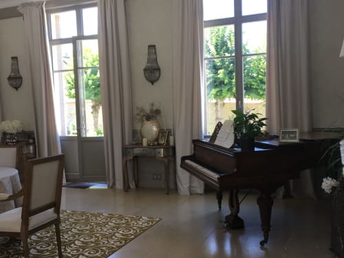 Elegant grand piano in bright room with tall windows at Le château d'Hermonville B&B in Hermonville, France