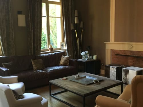 Elegant lounge at Le château d'Hermonville B&B in Hermonville, France with leather sofa, fireplace, and large windows