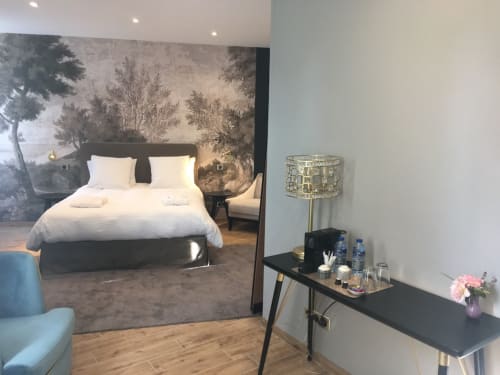 Modern bedroom at Le château d'Hermonville B&B in Hermonville, France, featuring a bed with white linens and forest mural