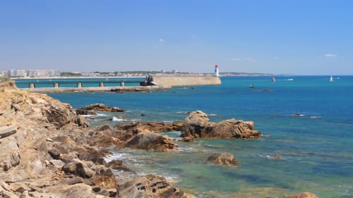 Rocky coastline with lighthouse at Les Sables-d'Olonne, Hôtel Maison Richet, France