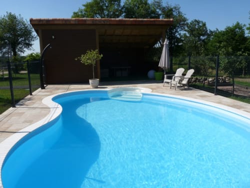 Swimming pool at Logis De La Bénétière in Treize-Vents with lounge chairs and poolside pavilion