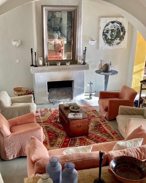 Cozy living room at Saint Martin B&B in Ollioules with fireplace, coral chairs, and arched ceiling