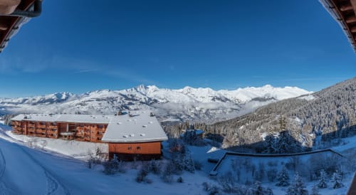 Cosyarc duplex apartment at Arc 1800 with Mont Blanc views, surrounded by snow-covered forests and ski slopes in