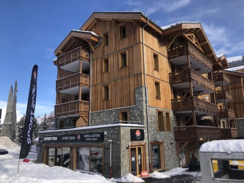Alpine lodge in Hermonville with wooden and stone facade, snow-covered grounds, mountain views, and ground-floor rental