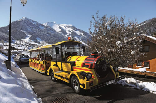 Little tourist yellow and red train, Châtel, resort, savoyard village, winter, snow.
