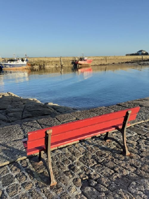 Bench at the entrance of the Barfleur harbour - Picturesque fish port in Normandy