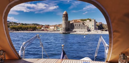 Vue de la ville côtière de Banyuls-sur-Mer depuis un bateau avec sa tour historique et son littoral méditerranéen