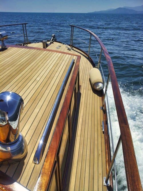 Luxury sailboat deck with wooden planks overlooking blue Mediterranean Sea near Banyuls-sur-Mer