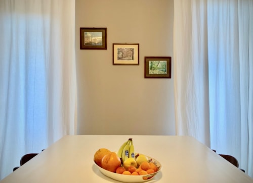 Mixed fruit tray on the white table in the common area - Bed Breakfast Ariel B&B - Rooms in Verona Center