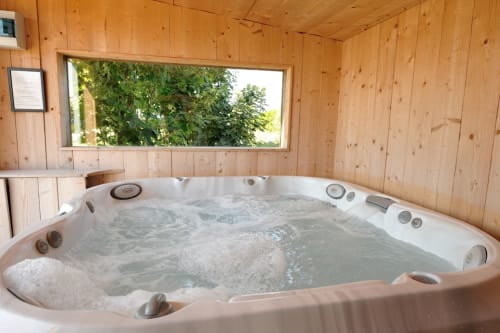 Hot tub with jets in wooden room at Espace Ker Gana B&B, Plourin, France
