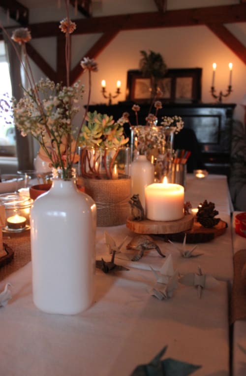 Elegant table setting at Espace Ker Gana with dried flowers, candles and warm lighting in Plourin
