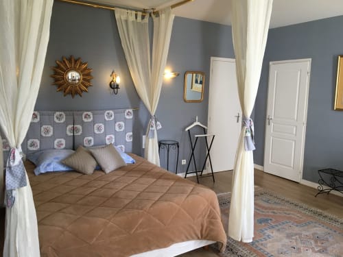 Elegant four-poster canopy bed in Superior Room at La Chatellenie B&B, Saint Aubin le Cauf, with blue walls and garden view