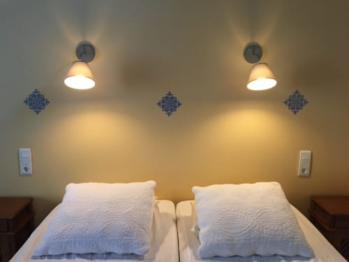 Twin beds with white quilted pillows in Grace Apartment at La Chatellenie B&B, Saint Aubin le Cauf, with wall sconces and