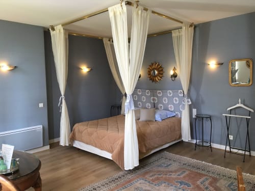 Luxurious canopy bed with cream drapes in elegantly decorated bedroom at La Chatellenie B&B, Saint-Aubin-le-Cauf