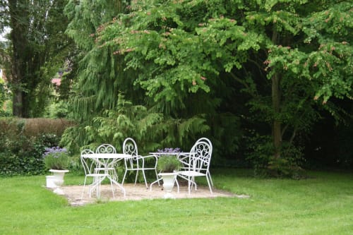 Wrought iron garden seating area at La Chatellenie B&B in Saint Aubin le Cauf, France