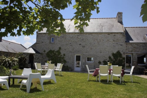 Stone cottage at Espace Ker Gana with lawn seating area in Plourin, France