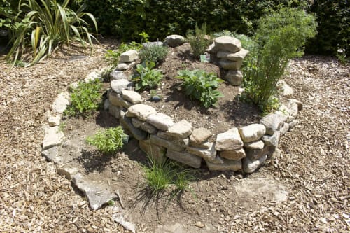 Zen garden with stacked stones and plants at Espace Ker Gana B&B in Plourin, France