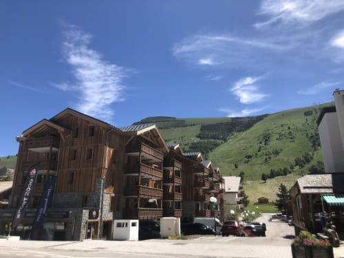 Le château d'Hermonville alpine lodge with wooden chalets overlooking green mountainside in Hermonville, France