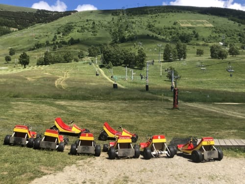 Red and yellow downhill go-karts lined up at ski resort near Château d'Hermonville, Hermonville France