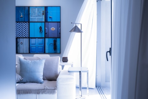 Suite Azul bedroom with sea view at French Riviera House Menton, blue doors artwork, minimalist decor, terrace access