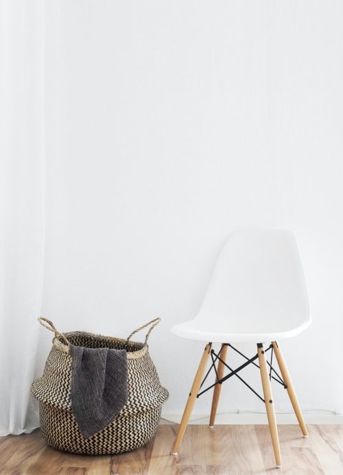 Modern white chair with wooden legs and woven basket in Riviera Suite at French Riviera House, Menton