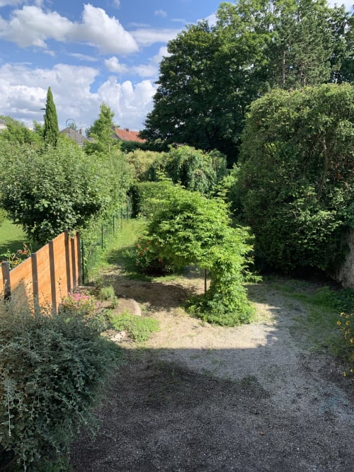 Lush garden pathway at Les Remparts De Joussaume Latour B&B in Château-Thierry, France