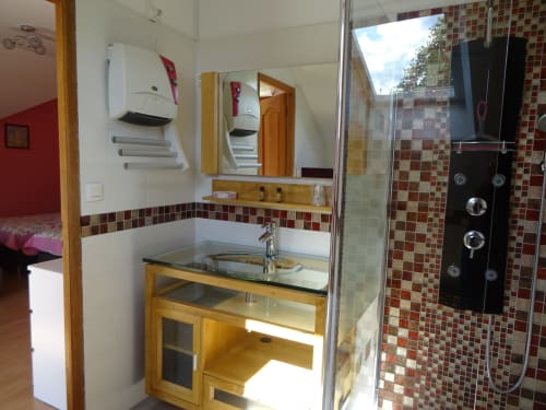 Salle de bain moderne de la chambre La Pepsie au CafecouetBreizh BnB, Guipry-Messac, avec douche vitrée, meuble vasque en bois et carrelage rouge