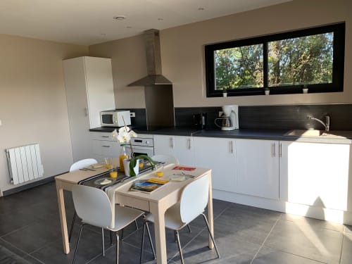 Modern kitchen and dining area in Cottage L'Olivier at Gites Mas D'en Ratéro with garden views